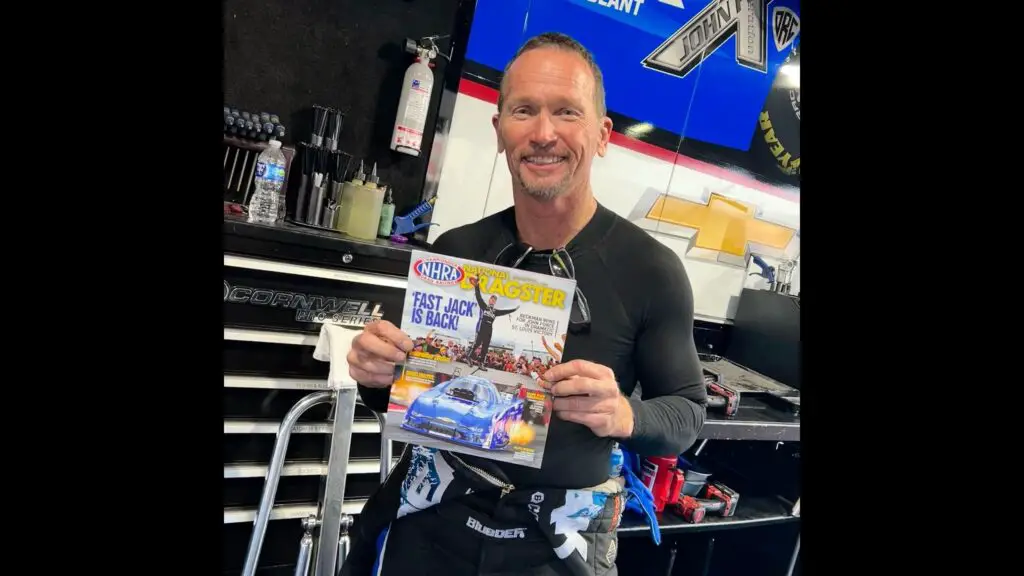 Funny Car driver Jack Beckman holding up the National Dragster with his national event win near St. Louis