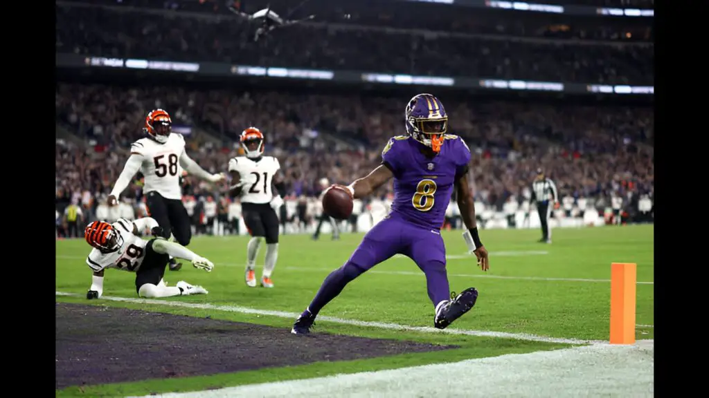 Baltimore Ravens quarterback Lamar Jackson carries the ball to score a two-point conversion during the second half of an NFL football game against the Cincinnati Bengals