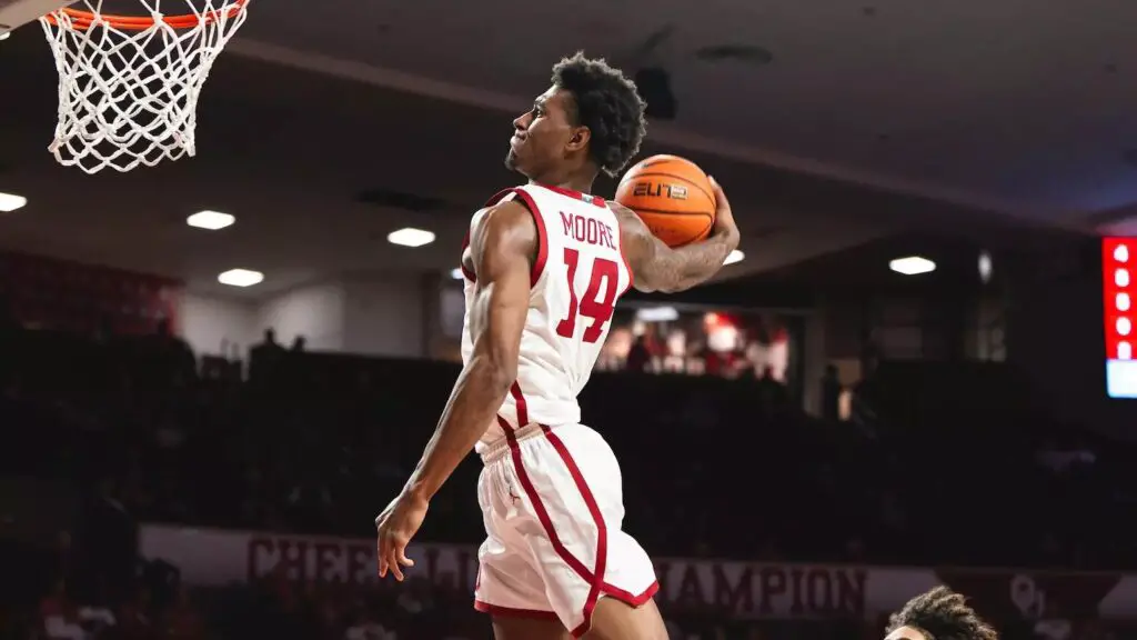 Oklahoma Sooners player Jalon Moore preparing to dunk the basketball in a game