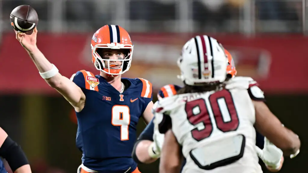 Illinois Fighting Illini quarterback Luke Altmyer looks to throw a pass against T.J. Sanders against the South Carolina Gamecocks in the fourth quarter during the 2024 Cheez-It Citrus Bowl