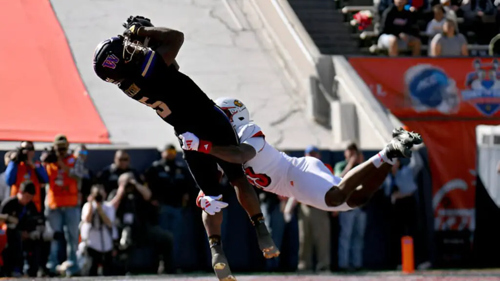 Washington Huskies wide receiver Giles Jackson catches a touchdown pass against defensive back Tahveon Nicholson against the Louisville Cardinals during the first half of the Tony the Tiger Sun Bowl 