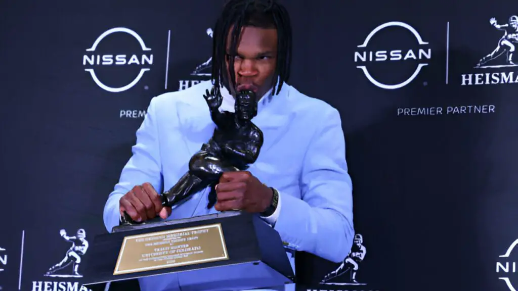 Colorado Buffaloes star cornerback and wide receiver Travis Hunter kisses the Trophy during the Heisman Trophy press conference