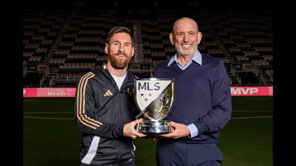 Lionel Messi and MLS Commissioner Don Garber with the MVP Trophy