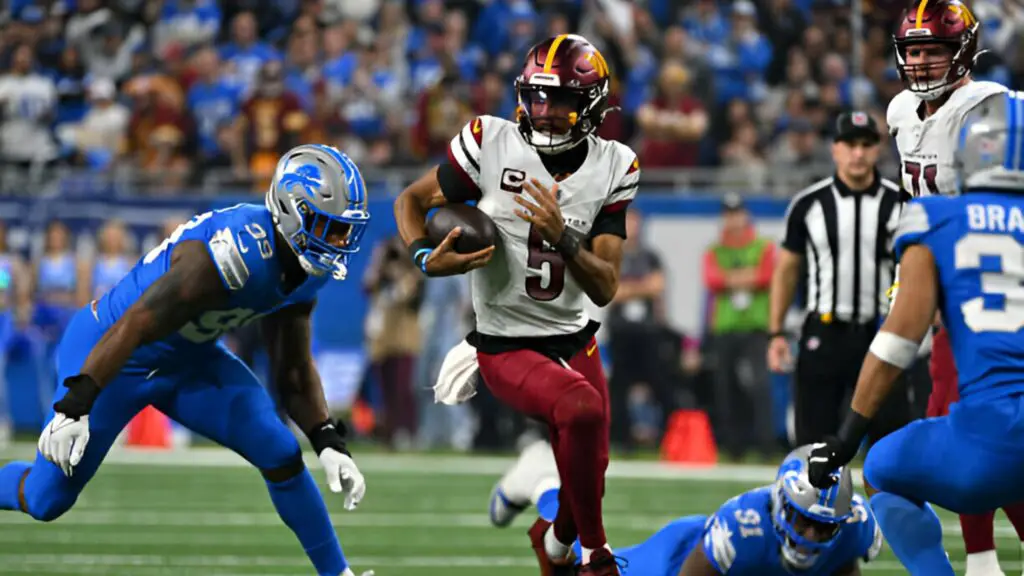 Washington Commanders quarterback Jayden Daniels runs wide during the NFC Divisional Playoff game against the Detroit Lions