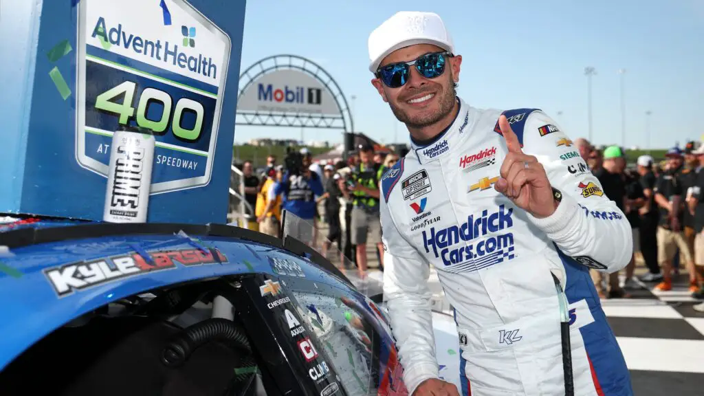 NASCAR Cup Series driver Kyle Larson poses with the winner sticker on his car in victory lane after winning the NASCAR Cup Series AdventHealth 400